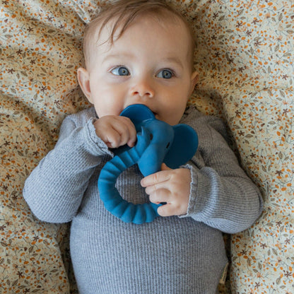 Baby with a blue elephant teether by Natruba, made from natural rubber