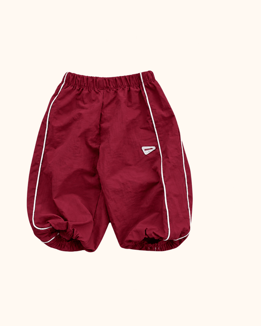 Burgundy Berry baby track pants with white piping by Black Bean