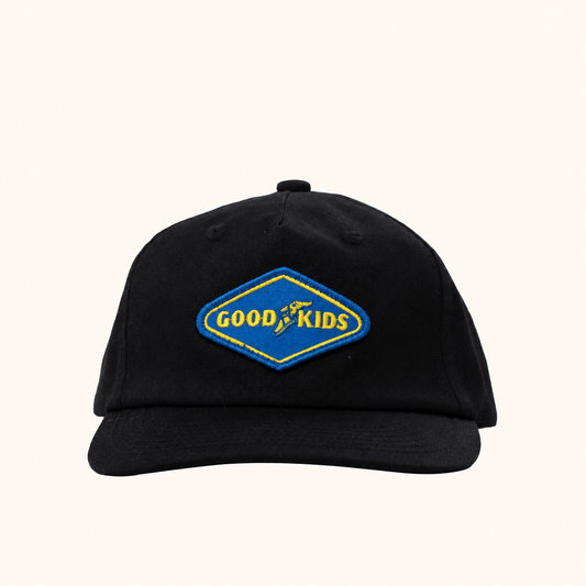 Black GOOD KIDS cap by Hello Harlow on a beige background