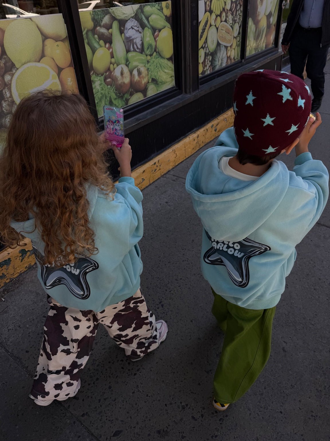 Child wearing burgundy Star Beanie with light blue stars by Hello Harlow