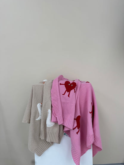 Roze Heartman vest naast beige Gordy Goose babydeken van Lennyco