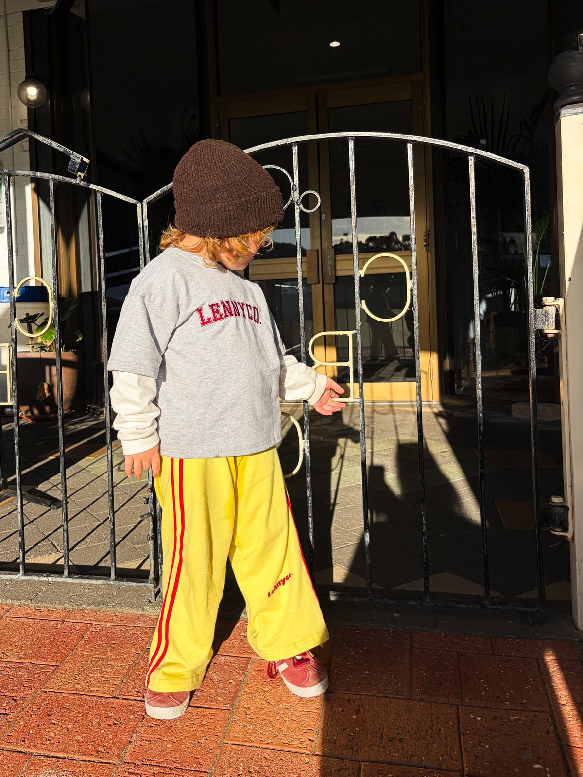 Grey and white layered long sleeve top by Lennyco with yellow pants
